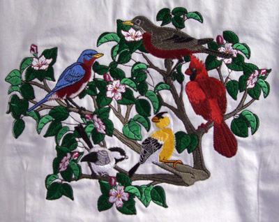 Embroidery of brids in a bush.